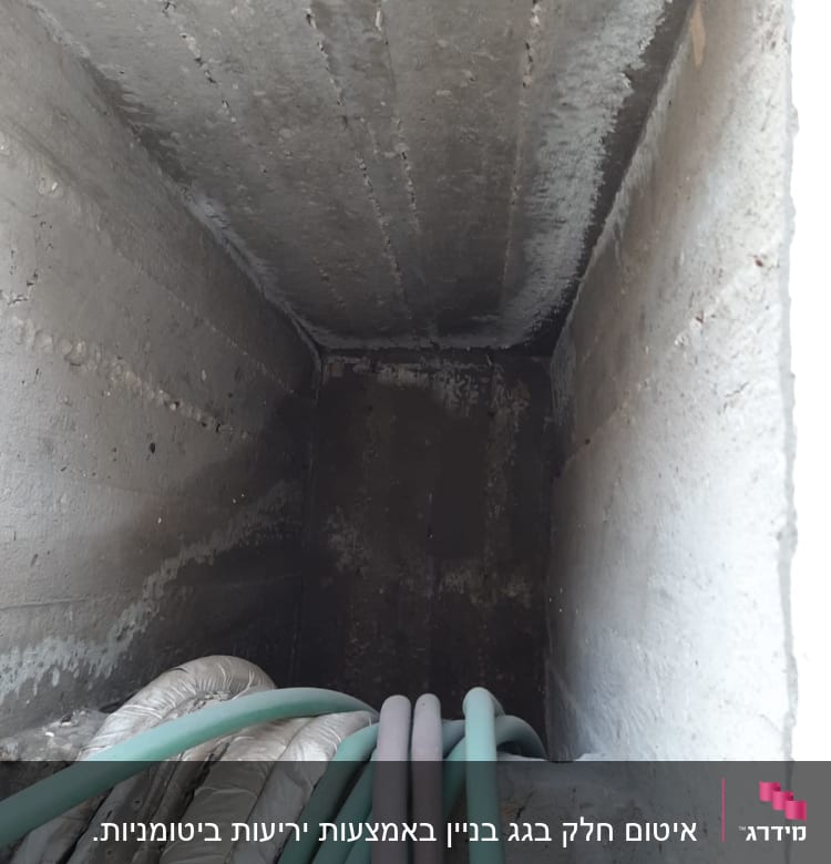 צינורות ירוקים ואפורים בתוך תעלת בטון